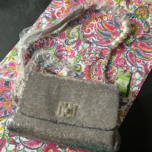 9"W x 6"H x 2" D Crossbody strap, multiple pockets inside, turn lock closure